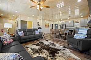 Relax in this stylish living area with a comfortable sofa, dining table, and modern kitchen.