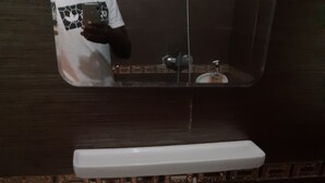 A bathroom sink with a mirror above it, a soap dispenser, and a faucet. - BEDROOM DAKAR PLATEAU (Dakar)