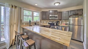 A kitchen with a wooden island, stainless steel appliances, and a view of the outdoors. - 4 Mi to Sugar Mtn Resort! Family-Friendly Retreat (Banner Elk)