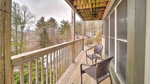A wooden deck with two wicker chairs, overlooking a residential area with trees and houses. - 4 Mi to Sugar Mtn Resort! Family-Friendly Retreat (Banner Elk)