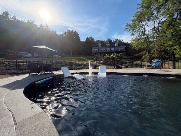 A swimming pool with lounge chairs, a fenced area, and a house in the background. - Breathtaking Mountainside Farm Resort -10 min to VA TECH, 20 to Aquatic Center (Blacksburg)