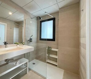 Shower, hair dryer, towels, toilet paper