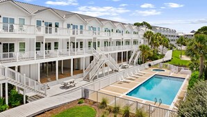 A multi-story hotel with balconies, a pool, and a well-maintained lawn. - FANTASTIC 2/2.5 TOWNHOME ON 30A!! SLEEPS 7!! WALKING DISTANCE TO GULF PLACE! (Santa Rosa Beach)