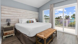 A bedroom with a bed, bench, nightstand, and a view of the outside. - FANTASTIC 2/2.5 TOWNHOME ON 30A!! SLEEPS 7!! WALKING DISTANCE TO GULF PLACE! (Santa Rosa Beach)
