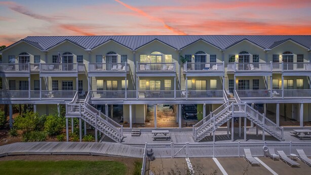 A multi-story hotel with balconies, a covered outdoor area, and a pool. - FANTASTIC 2/2.5 TOWNHOME ON 30A!! SLEEPS 7!! WALKING DISTANCE TO GULF PLACE! (Santa Rosa Beach)