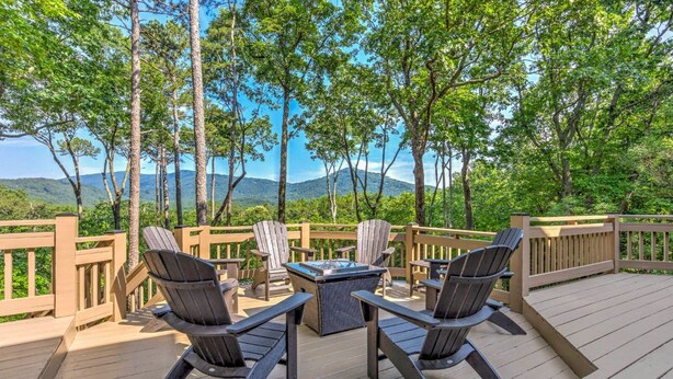 A deck with outdoor furniture, a fire pit, and a scenic mountain view. - Hillside Manor - Luxury Hot Tub + Fireplace + Pool Table + & Wet Bar (Jasper)