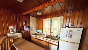 A compact kitchen with a microwave, stove, sink, and refrigerator. - Two Bedroom Cabin On The Beach, sleeps 6 (Au Sable Charter Township)