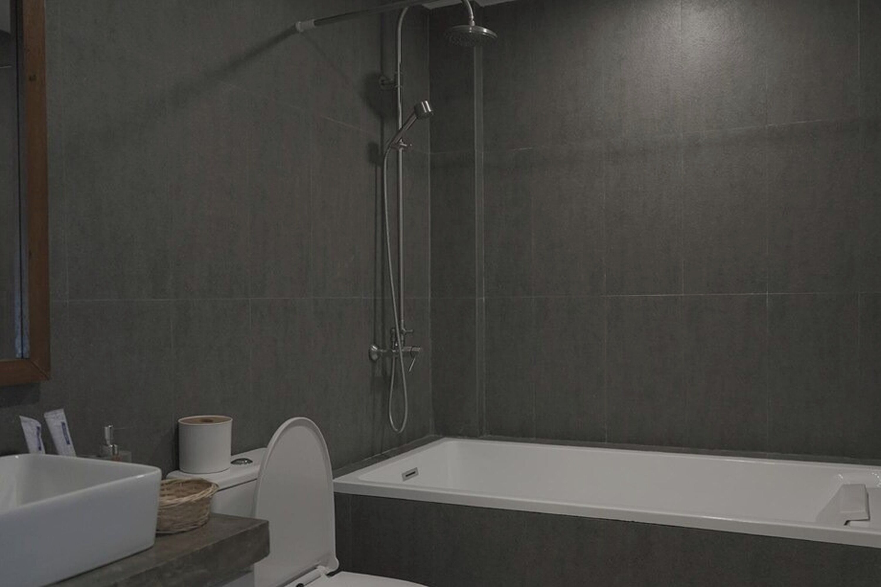 A modern bathroom with a bathtub, a toilet, and a sink.