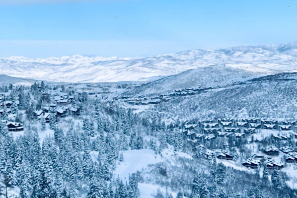 A snowy mountain landscape with a village of houses.
