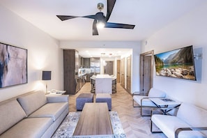A modern living room with a sofa, coffee table, and a TV mounted on the wall. - Westgate 4201 (Park City)