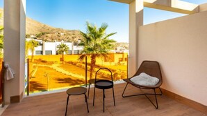 A balcony with a view of a residential area, featuring palm trees and a mountain in the background. - Alegría Village by Interhome (Benidorm)