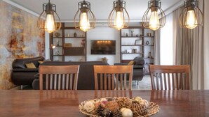 Un comedor con una mesa de madera, sillas y un cesto de objetos decorativos.