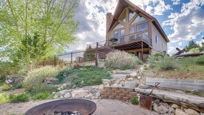A modern log cabin with a large deck, stone walls, and a fire pit. - Rustic Sterling Cabin: Walk to Palisade Lake! (Sterling)