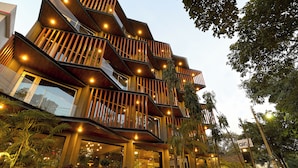 A modern multi-story building with balconies and outdoor lighting. - AIR by Ahuja Residences (Gurugram)