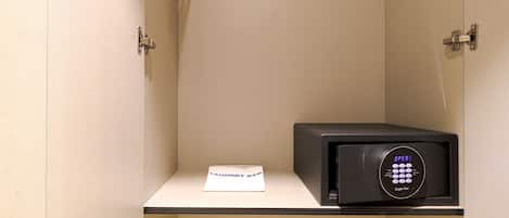 A small, enclosed space with a microwave and a note labeled "laundry bag" on a counter.