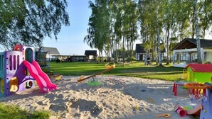 A playground with a seesaw, a slide, and a sandpit. - Holiday studio with terrace (Jaroslawiec)