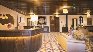 A lobby with a reception desk, a sofa, patterned flooring, and a ceiling with wooden beams. - Thrace Konak Hotel & Spa (Kirklareli)