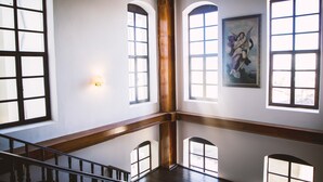 A spacious interior with high ceilings, large arched windows, and a wooden staircase. - Thrace Konak Hotel & Spa (Kirklareli)