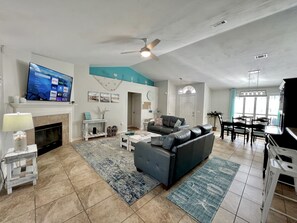 Relax in the living room with a comfortable sofa, flat-screen TV, and dining area.