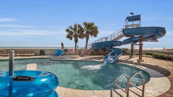 Relax by the pool surrounded by palm trees and enjoy a clear view of the beach.