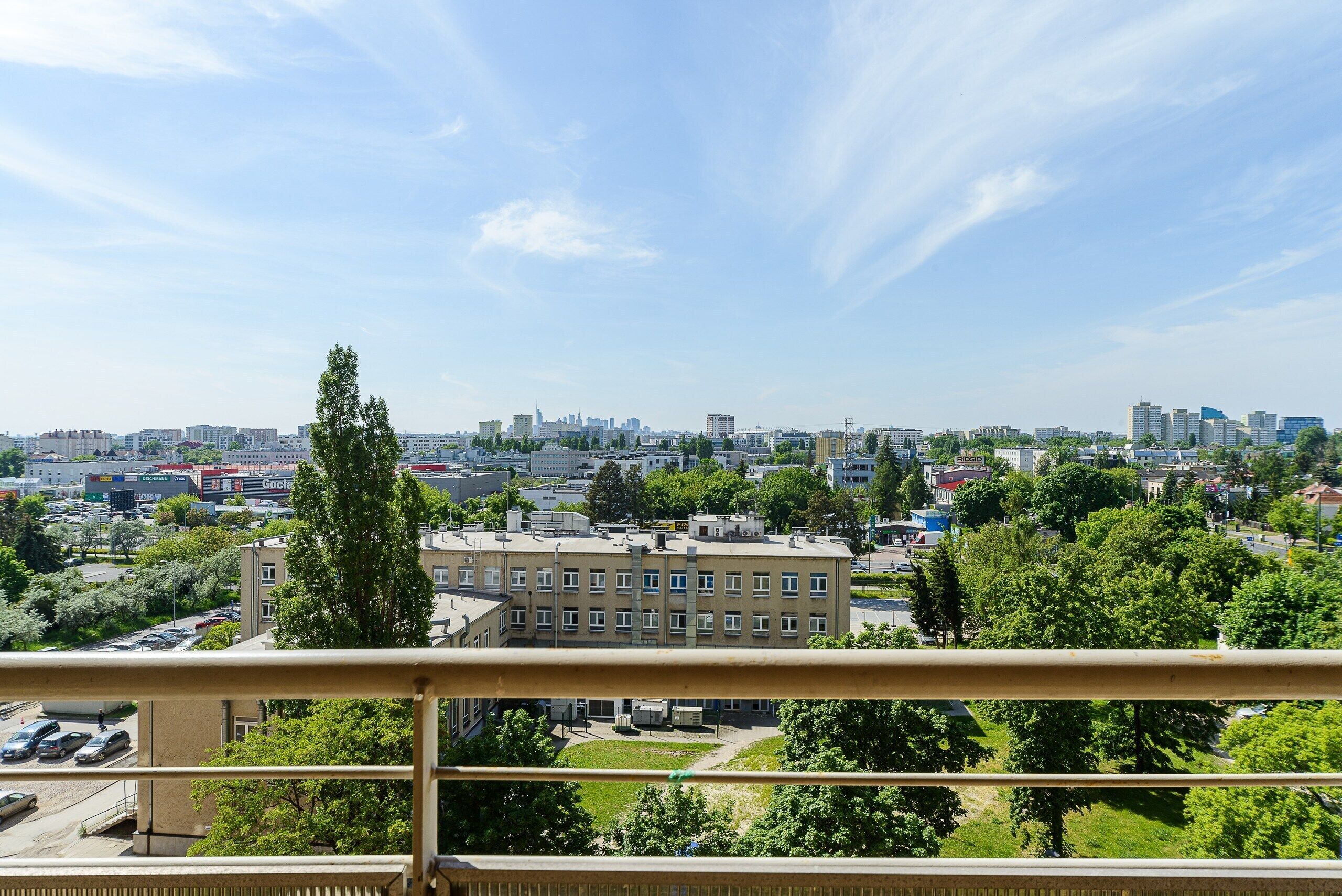 A cityscape with buildings, trees, and a clear sky.