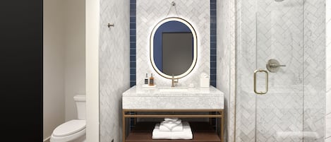 A modern bathroom with a white toilet, a vanity with a mirror, and a shower area.