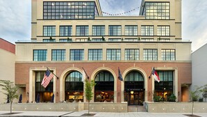 A multi-story hotel with a modern architectural design, featuring a brick facade and large windows. - The Restoration Asheville (Asheville)