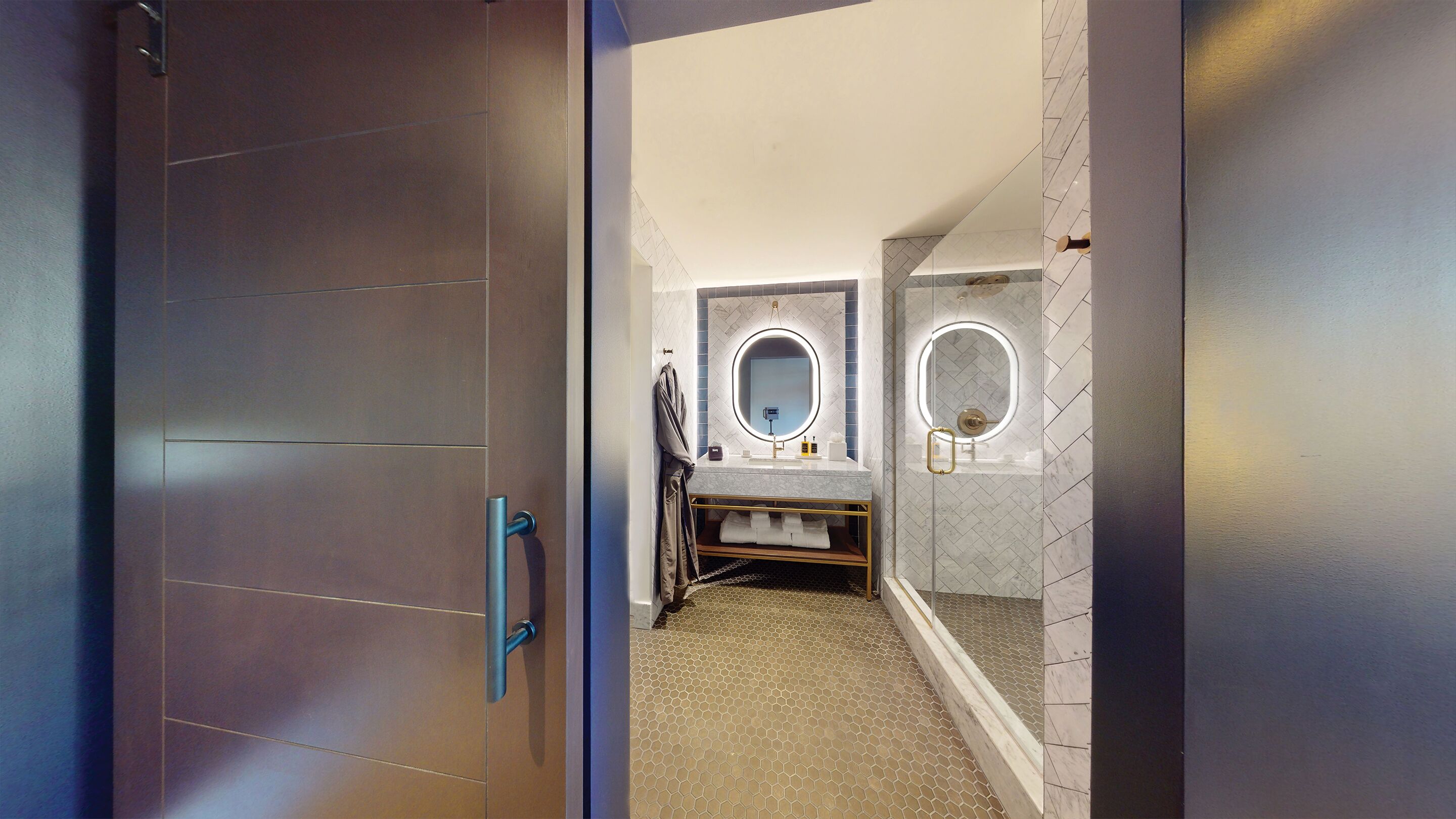 A bathroom with two sinks, a towel rack, and a mirror.