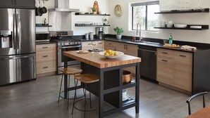 A modern kitchen with a central island, stainless steel appliances, and wooden accents.