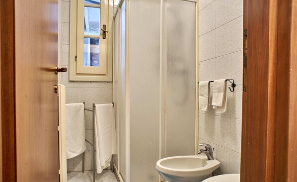 A bathroom with a sink, a mirror, and a towel rack.
