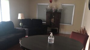 A dining area with a round table, chairs, and a bottle of hand sanitizer. - Lovely 3bdrm home walking distance from Masters (Augusta)