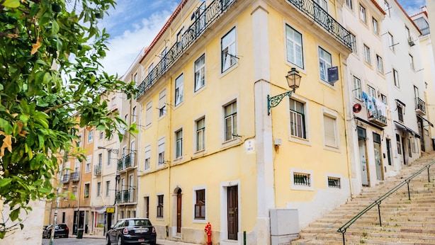 A yellow building with a staircase leading to an upper floor. - 1BR Apartment - Downtown Lisbon - Chiado (Lisbon)