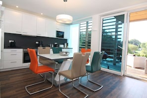 Enjoy meals at the dining table with a contemporary design, accompanied by two comfortable chairs.