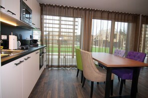 Enjoy meals in the kitchen with microwave and oven, and dine at the wooden table with four chairs.