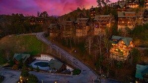 A lodge with multiple buildings, a parking area, and a road. - NERF War-Family Lodge-Theater-HotTub-GlowParty (Sevierville)