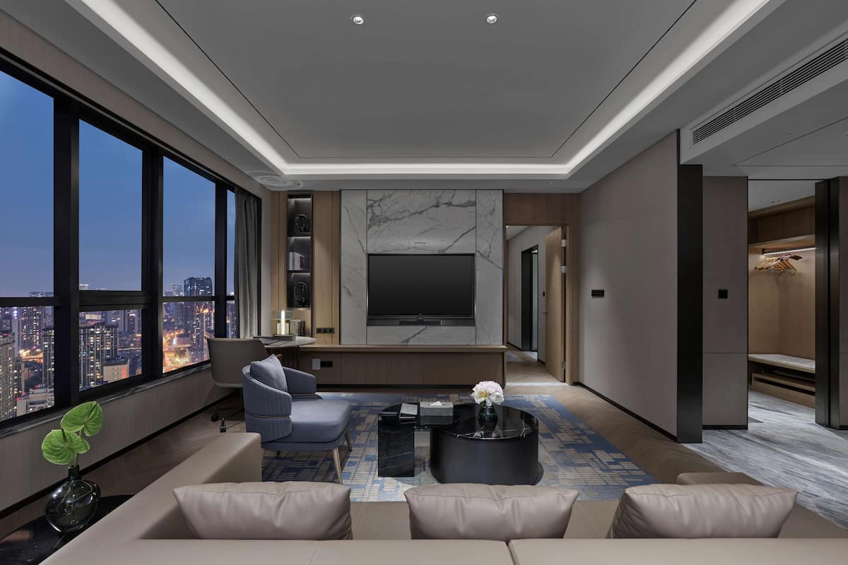 Premium Suite, 1 King Bed | Living area | 65-inch TV with cable channels