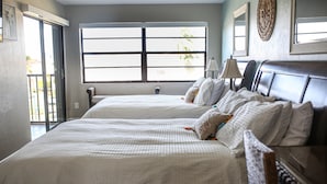 A hotel room with two beds, a large window, and a view of the outdoors. - ANGLERS COVE - WELCOME TO "ISLAND TIME" AT MARCO ISLAND (Marco Island)