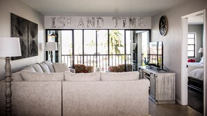 A living room with a large sofa, a TV, and a sign that reads "ISLAND TIME". - ANGLERS COVE - WELCOME TO "ISLAND TIME" AT MARCO ISLAND (Marco Island)