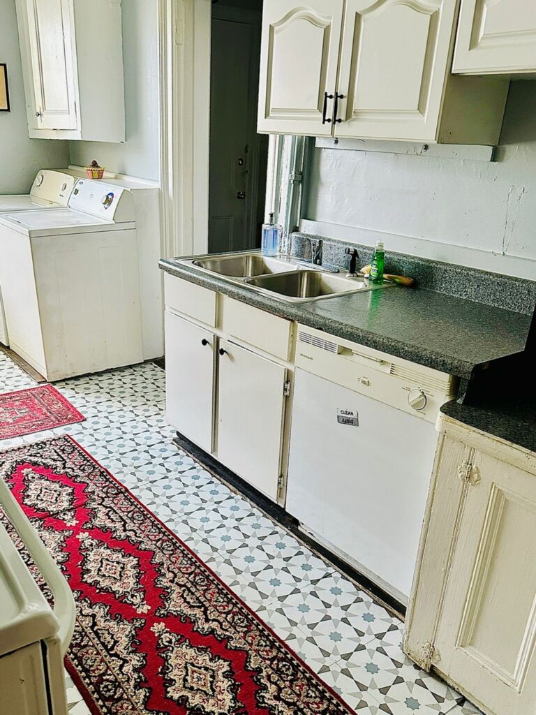 A compact kitchen with a dishwasher, a sink, and a countertop.