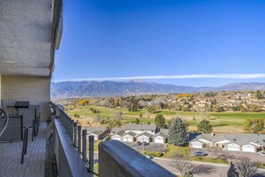 A residential area with houses, a clear sky, and mountains in the background.