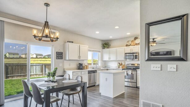 A modern kitchen with white cabinets, stainless steel appliances, and a large island. - 3bdquiet Suburbsthe Perfect Get Away (Colorado Springs)