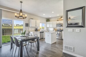 A modern kitchen with white cabinets, stainless steel appliances, and a large island. - 3bdquiet Suburbsthe Perfect Get Away (Colorado Springs)
