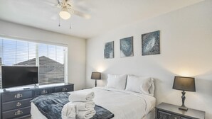 A bedroom with a bed, two bedside tables, a TV, and artwork on the wall. - 3bdquiet Suburbsthe Perfect Get Away (Colorado Springs)