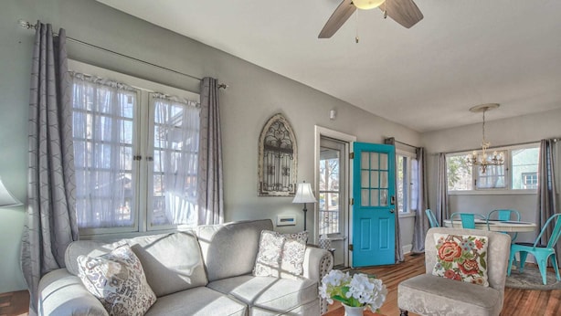 A living room with a sofa, a coffee table, and a dining area with chairs and a table. - 1bdlovely Cottagedogs Welcome!near Olympic Training Center (Colorado Springs)
