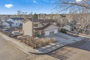A two-story house with a garage, a driveway, and a fenced backyard. - 2bdcentrally Locatedclose to Shops & Restaurants! (Colorado Springs)