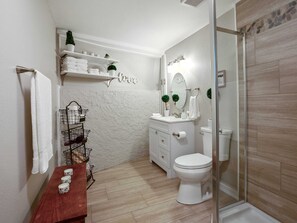 A modern bathroom with a white vanity, a glass shower enclosure, and a wooden bench. - Crystal Cabin Pikes Peak Mountain w/ Wine Cellar (Divide)