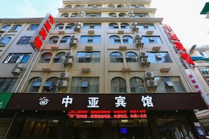 A multi-story hotel with a prominent sign for '中亚宾馆' and a visible storefront with a sign for '中亚宾馆'. - Zhongya Hotel (Nanning)
