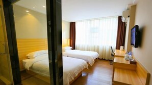 A hotel room with two beds, a television, a desk, and a window with curtains. - Zhongya Hotel (Nanning)