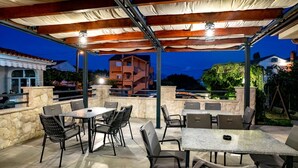 An outdoor patio with stone walls, tables, and chairs. - Apartment in Lopar with Balcony, Air condition, WIFI (4739-4) (Lopar)