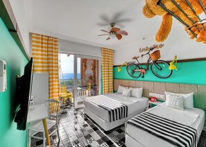 A hotel room with two beds, a ceiling fan, a bicycle wall decoration, and a view of the outdoors.
